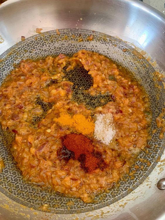 Step 2.1: Mix in salt, red chilli powder, turmeric, and 2–3 tablespoons of water
