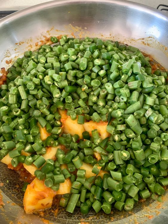 Step 2.1: Add the beans, pour in ¼ cup water, cover, and cook over low-medium heat until the beans are tender and potatoes are fully cooked