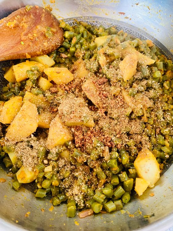 Step 2.1: Stir in coriander powder, anardana (or substitute), garam masala, and fresh coriander leaves