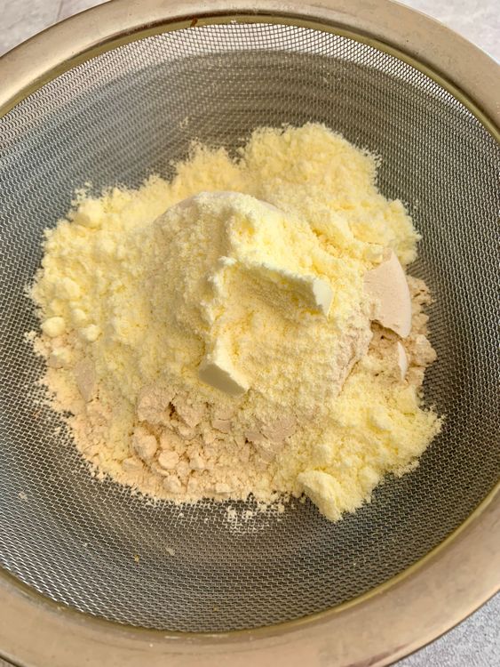 Step 1.1: In a bowl, sift together wheat flour, baking powder, baking soda, and milk powder