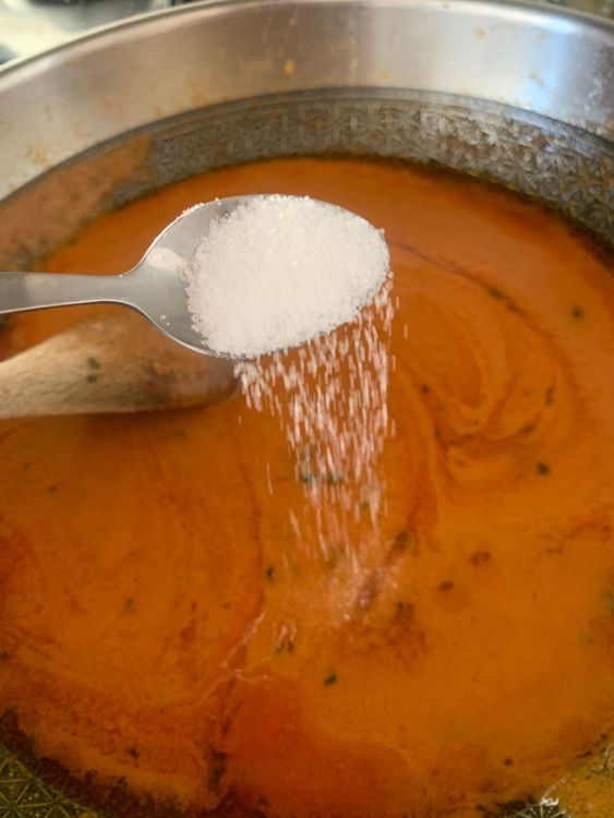 Step 2.2: Pour in the ground mixture, add sugar and green chillies, and mix