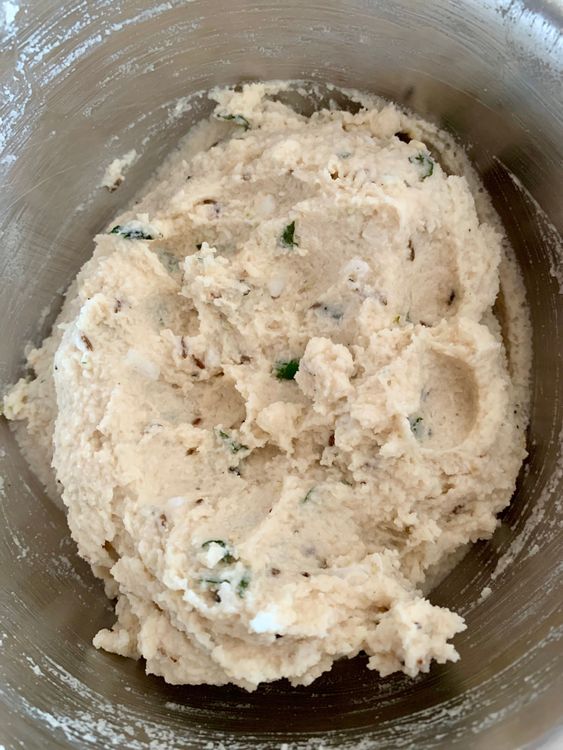 Step 2.1: Transfer the batter to a bowl, add ginger, green chilli, cumin seeds, black peppercorns, coconut, curry leaves, asafoetida, baking soda and salt