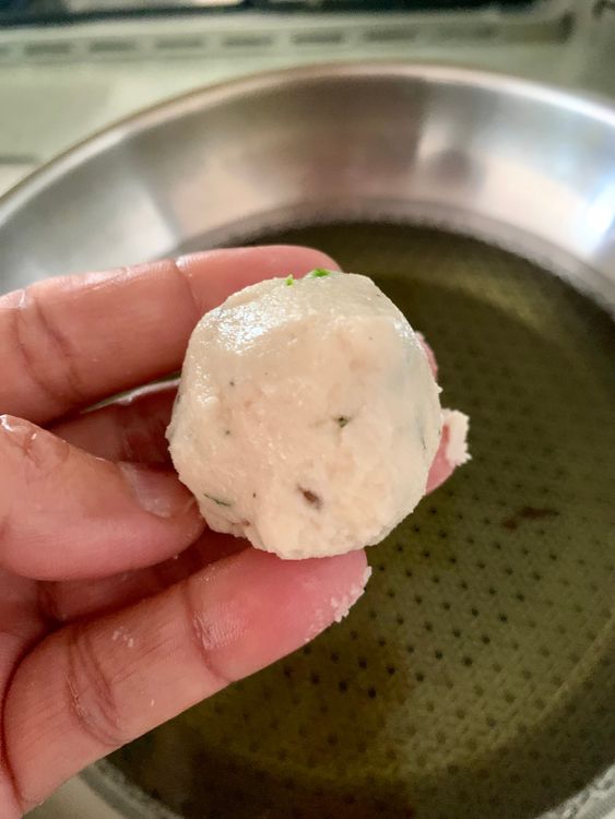 Step 2.1: Wet your hands, take a small portion of the batter using your fingers or a small round ladle and drop it gently into the hot oil