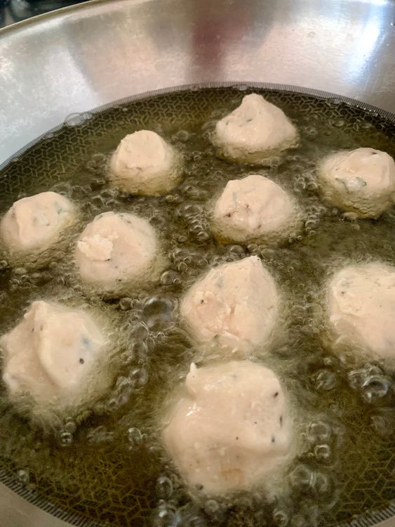 Step 2.2: Wet your hands, take a small portion of the batter using your fingers or a small round ladle and drop it gently into the hot oil