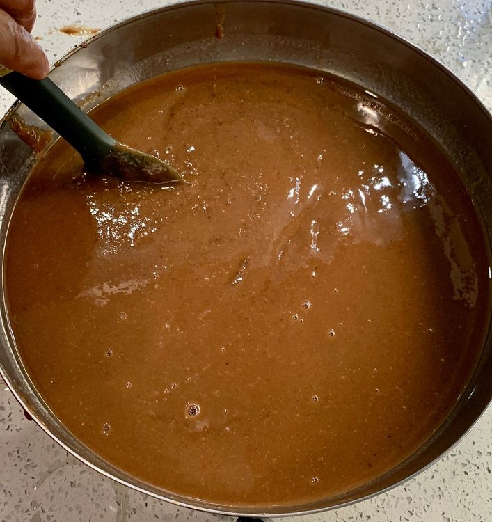 Step 1.2: Strain the mixture through a fine-mesh sieve, pressing the tamarind pulp with a spoon to extract as much liquid as possible