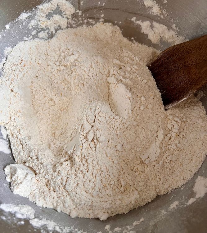 Step 1.1: In the bowl of your stand mixer (or a regular bowl, if you aren't using one), add your flour, cornmeal or whole wheat flour, yeast, and salt