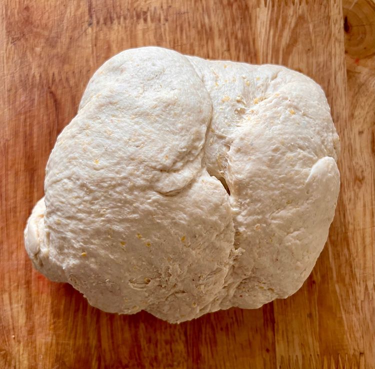 Step 1.1: With the standmixer running on low, slowly add your water mixture and let it run until a dough forms