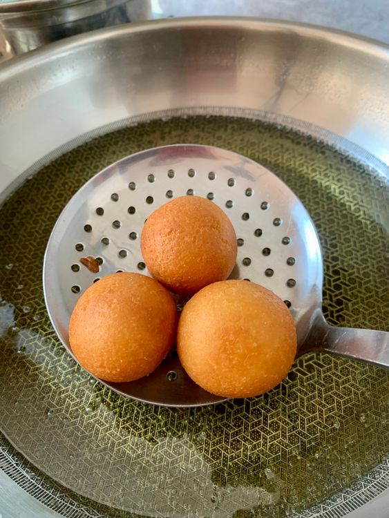 Step 3.1: Fry on medium heat, turning occasionally, until the jamuns are evenly golden brown and cooked through
