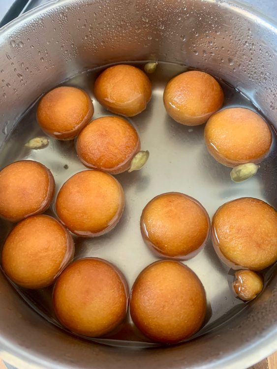 Step 3.1: Remove with a slotted spoon and transfer directly into the warm sugar syrup