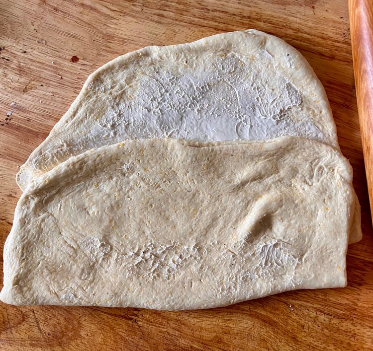 Step 1.1: Once you've spread the butter, fold each piece of dough over itself twice, like you would a business letter