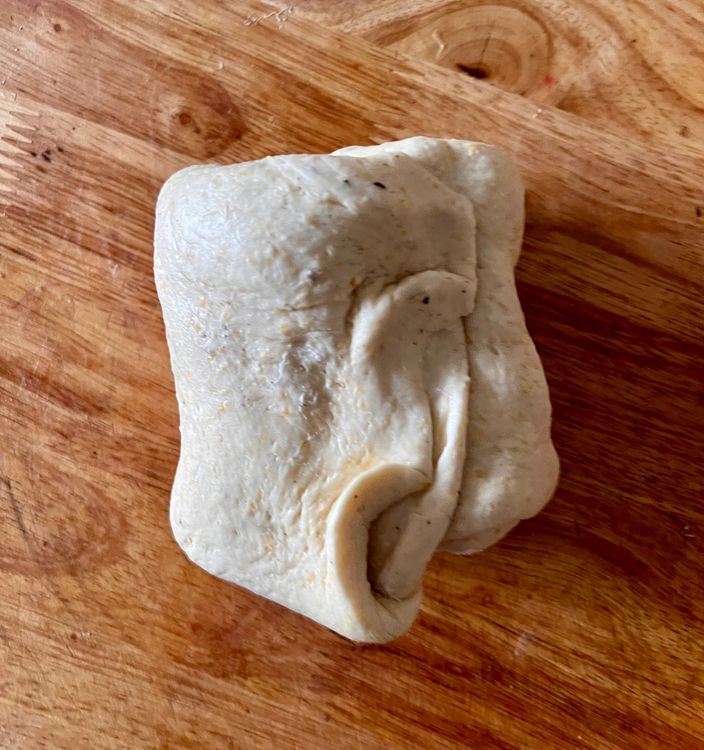 Step 1.3: Once you've spread the butter, fold each piece of dough over itself twice, like you would a business letter