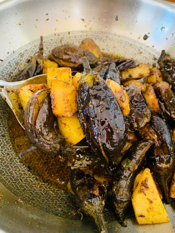 Step 3.1: Cover and cook on low–medium heat until the brinjals turn soft and the potatoes are perfectly tender