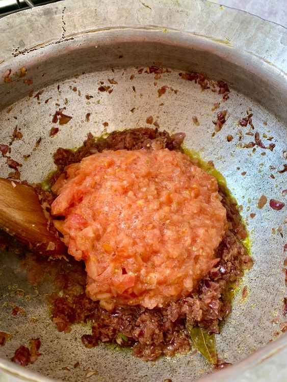 Step 2.1: Add tomatoes and cook until soft and mushy