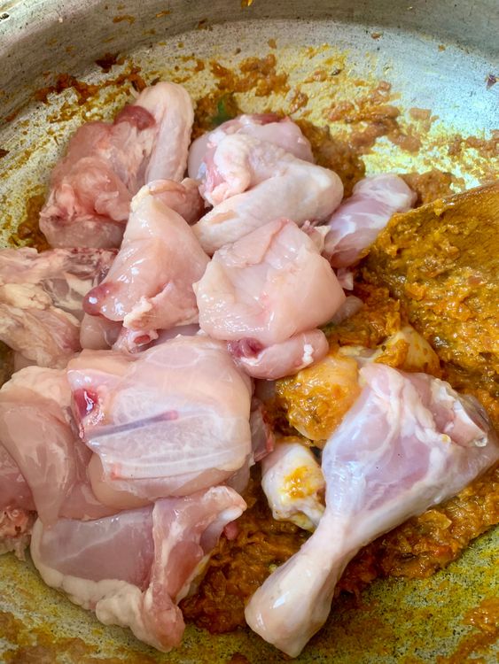 Step 3.1: Add chicken pieces and sauté for 5–6 minutes until they change colour and are well coated with masala
