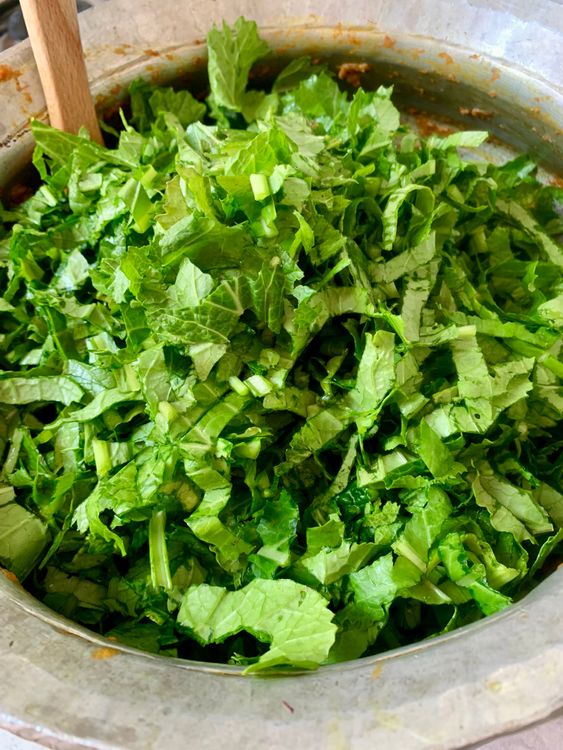 Step 4.1: Add the chopped mustard greens and stir