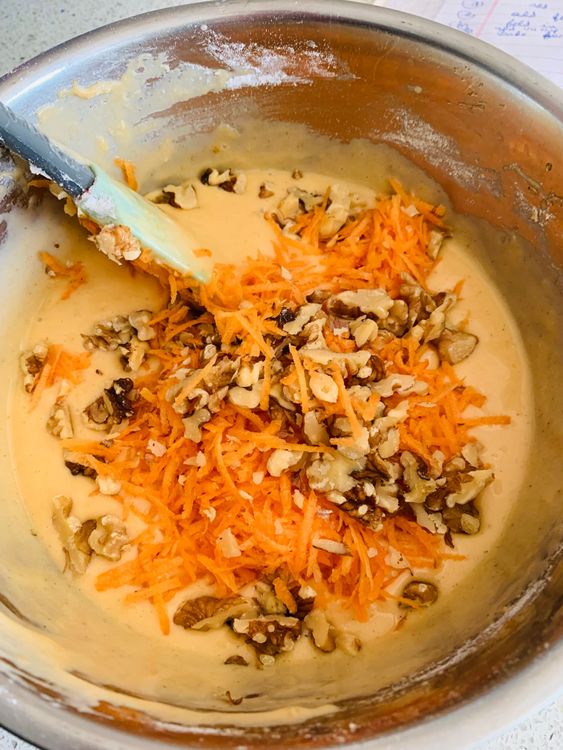 Step 4.1: Fold in the grated carrot and chopped walnuts, stirring lightly in one direction