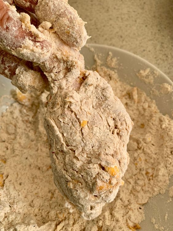 Step 4.2: Dip in the egg mixture, then coat again in the flour mix, pressing firmly so the crust sticks
