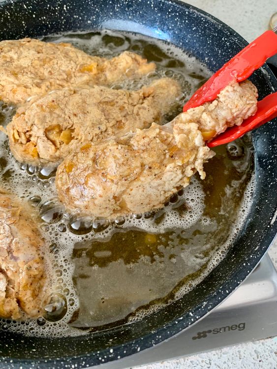 Step 5.2: Fry the chicken in batches for 3–4 minutes undisturbed, then another 8–10 minutes, turning occasionally, until golden brown and fully cooked