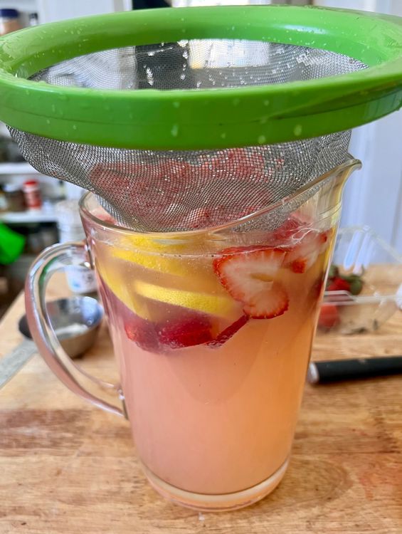 Step 1.1: In the pitcher you’re serving the lemonade from, add the rest of your sliced strawberries and sliced lemons