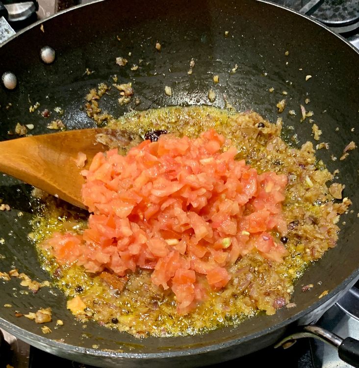 Step 1.1: Mix in the chopped tomatoes until they become mushy