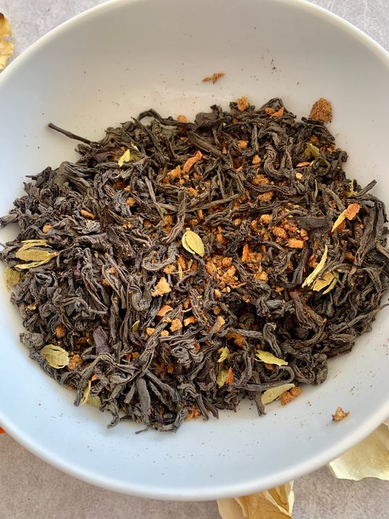 Step 1.1: Add finely chopped ginger, nutmeg powder, and tea leaves to the coarsely ground spices