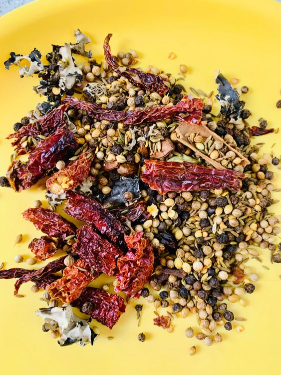 Step 2.1: Heat a pan over medium flame and dry roast the red chillies, coriander seeds, peppercorns, fennel seeds, cumin, cardamoms, cinnamon, cloves, star anise, and stone flower until fragrant