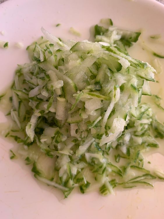 Step 1.1: Grate the cucumber with the peel intact, allowing the excess water to remain