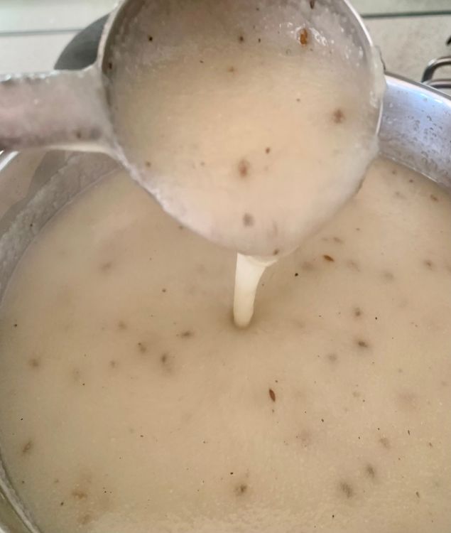 Step 1.1: Once soaked, transfer the suji mixture to a pot and bring it to a boil on medium heat, stirring continuously to prevent lumps