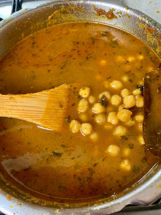 Step 3.1: Option 1 - Pressure Cooker - Pressure cook for 1 whistle on high heat, then reduce flame and cook for 6-8 whistles (or longer, if needed) until chickpeas are soft