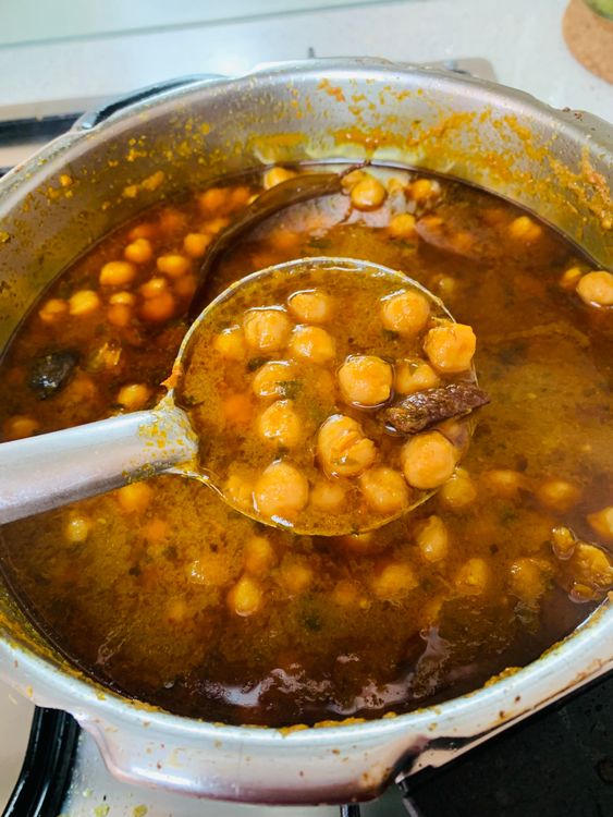 Step 3.2: Option 1 - Pressure Cooker - Pressure cook for 1 whistle on high heat, then reduce flame and cook for 6-8 whistles (or longer, if needed) until chickpeas are soft