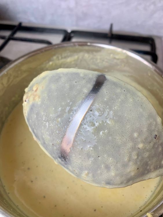 Step 1.1: To check consistency, dip a ladle into the phirni and run your finger across the back