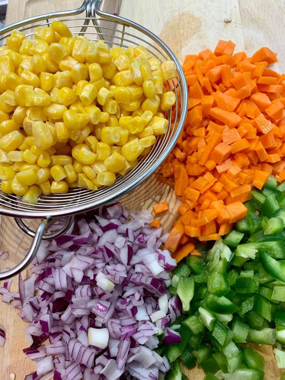 Step 1.1: Finely chop the onion, carrots and capsicum and keep them aside