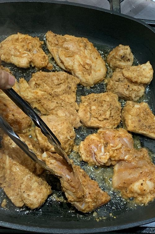 Step 1.2: Once the oil is hot, place the marinated chicken in the pan and sear them from both sides for about 3-4 minutes