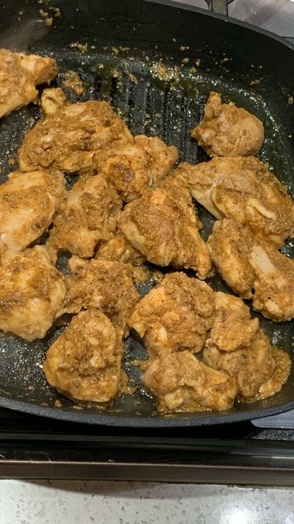 Step 1.1: Reduce the heat to medium and continue cooking the chicken for 15-20 minutes, flipping it occasionally, until it is cooked through and evenly golden