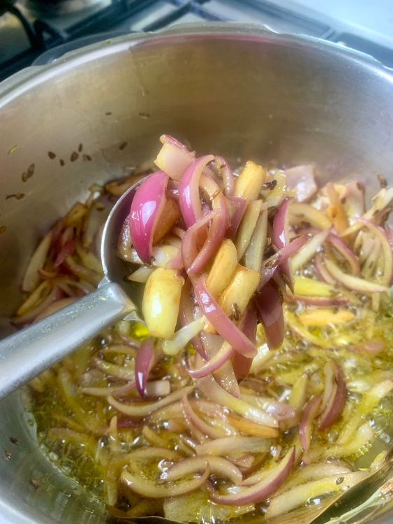 Step 3.2: Add sliced garlic, sauté until golden, then add onions and cook until soft and translucent