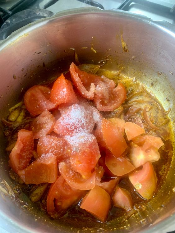 Step 3.1: Add tomatoes and salt, and cook until the tomatoes break down and the oil begins to separate