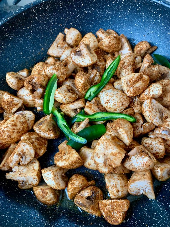 Step 2.1: Add the marinated mushrooms and slit green chillies