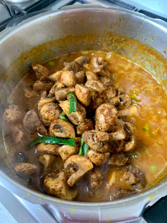 Step 5.1: Now add the sautéed mushrooms, mix gently, and pressure cook again for 2–3 whistles