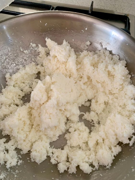 Step 1.2: In a heavy-bottomed pan, add coconut and milk