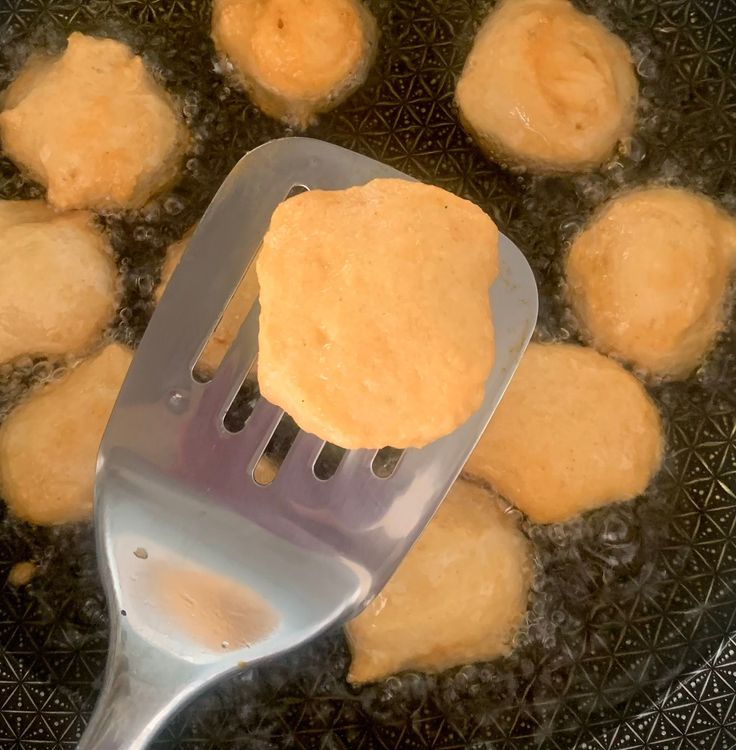 Step 4.1: Carefully slide them into the hot oil, frying until golden brown (avoid overcrowding by frying in batches)