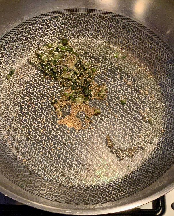 Step 1.1: Add finely chopped green chillies, curry leaves and carom seeds to the pan