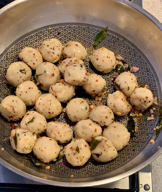 Step 2.1: Add the steamed semolina balls to the pan and stir until they are evenly coated