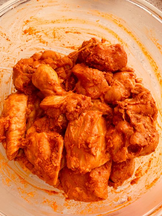 Step 1.1: Combine chicken, oil, red chilli powder, garam masala, turmeric, Kashmiri chilli powder, ginger and garlic paste, salt, cornflour, and 2 tablespoons of lemon juice in a large bowl