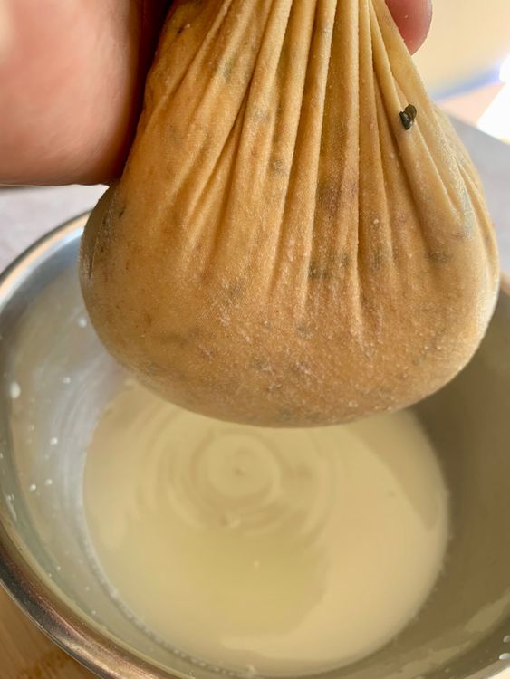 Step 1.1: Over a bowl, place a muslin cloth-lined colander and pour the curdled milk to separate the curds from the whey