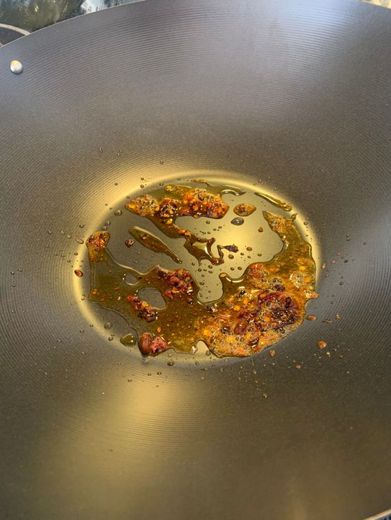 Step 1.1: Heat a wok over medium heat and add chilli oil
