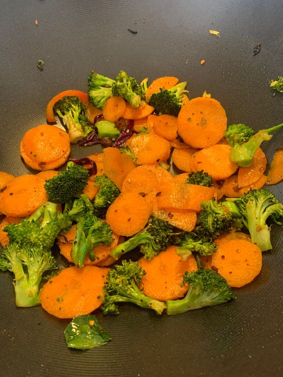 Step 1.1: Add the sliced carrots and broccoli to the wok and cook on medium-high heat for 3-4 minutes or until slightly softened