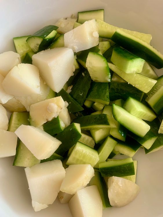 Step 1.1: Add the cucumbers and cubed boiled potatoes to a mixing bowl