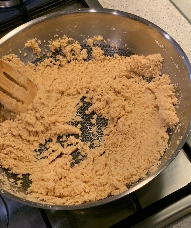 Step 1.2: Once the ghee is hot, add the suji to the pan and stir continuously