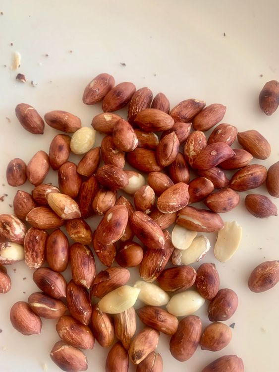 Step 2.1: In the same pan, roast the peanuts until golden