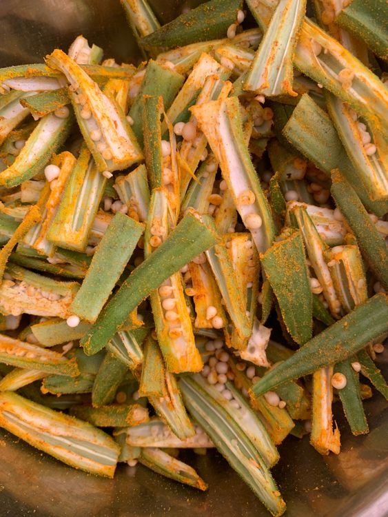 Step 1.1: Sprinkle turmeric, red chilli powder, and cumin powder over the sliced okra